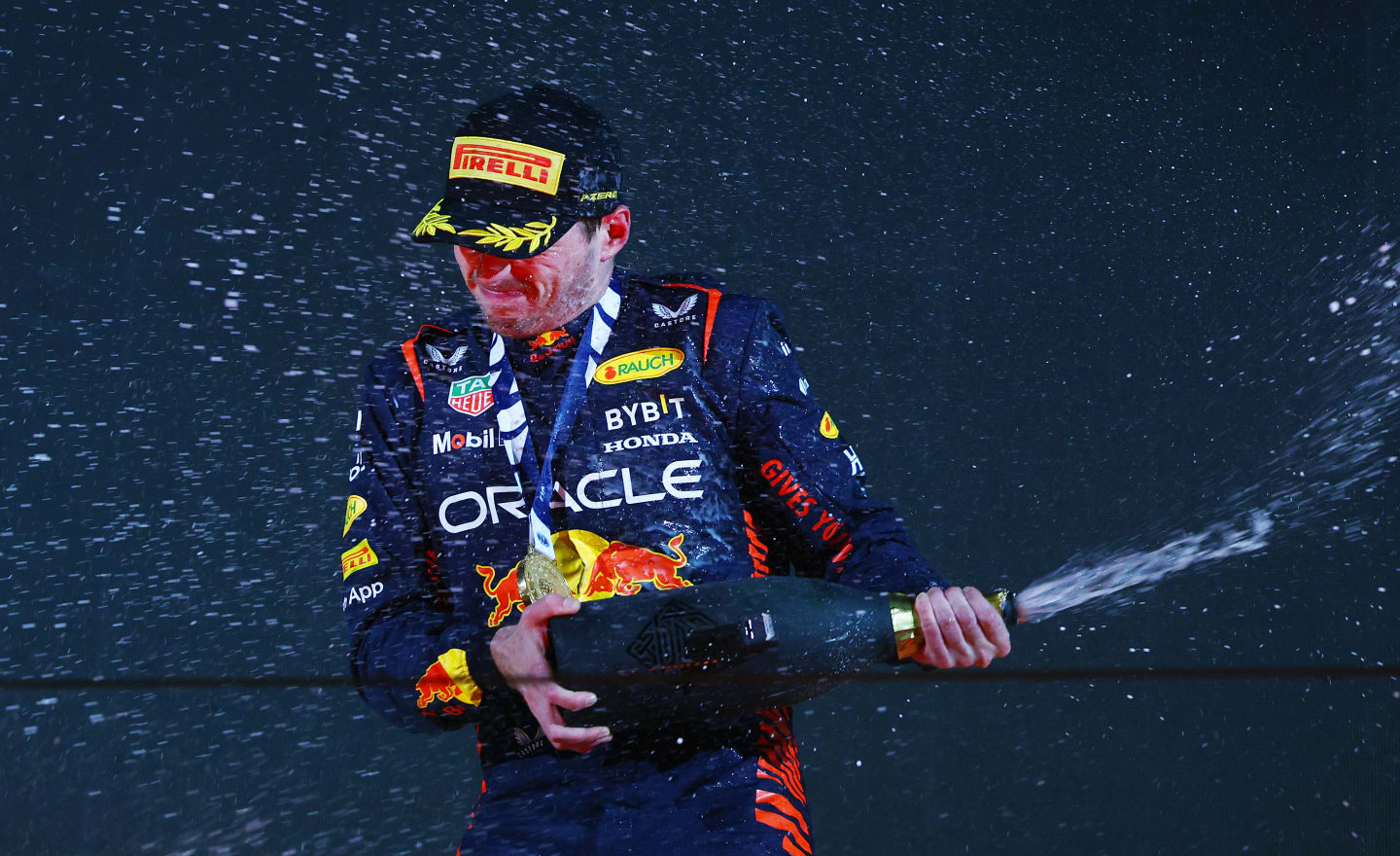 BAHRAIN, BAHRAIN - MARCH 05: Race winner Max Verstappen of the Netherlands and Oracle Red Bull Racing celebrates on the podium during the F1 Grand Prix of Bahrain at Bahrain International Circuit on March 05, 2023 in Bahrain, Bahrain. (Photo by Mark Thompson/Getty Images)