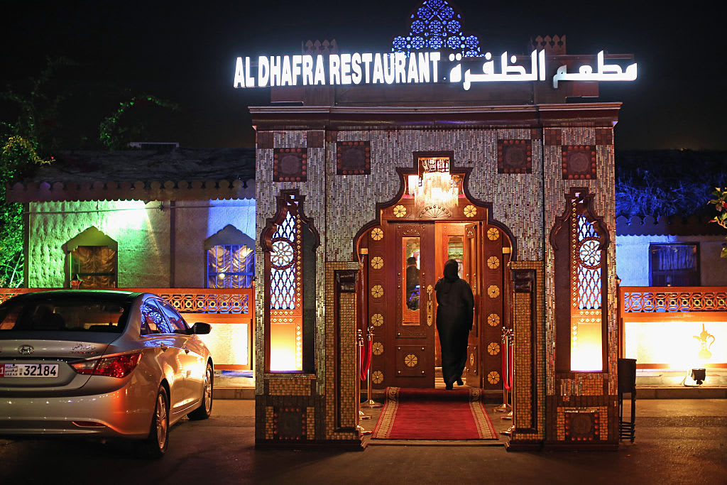 ABU DHABI, UNITED ARAB EMIRATES - FEBRUARY 05:  A woman enters the Al Dhafra Restaurant at Dhow