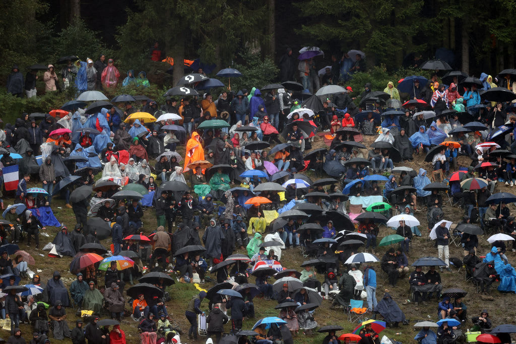 SPA, BELGIUM - AUGUST 28: Fans shelter from the rain during qualifying ahead of the F1 Grand Prix