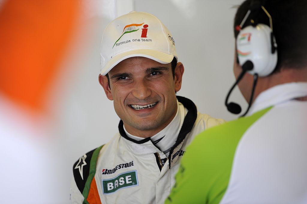 Force India's Italian driver Tonio Liuzzi smiles in the pits of the Yas Marina Circuit on October
