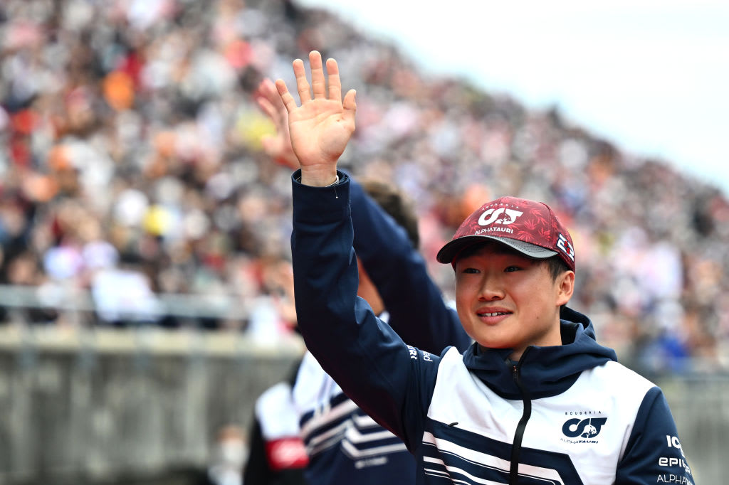 SUZUKA, JAPAN - OCTOBER 09: Yuki Tsunoda of Japan and Scuderia AlphaTauri waves to the crowd on the