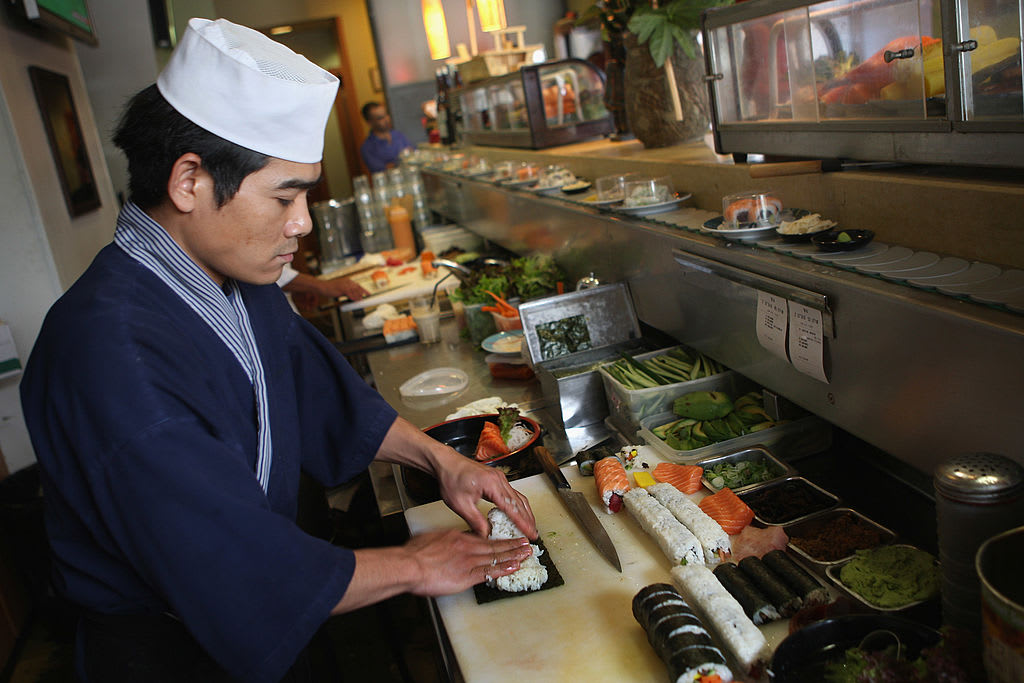 HERZLIYA, ISRAEL - APRIL 25:  A chef prepares sushi at the Running Sushi restaurant April 25, 2008