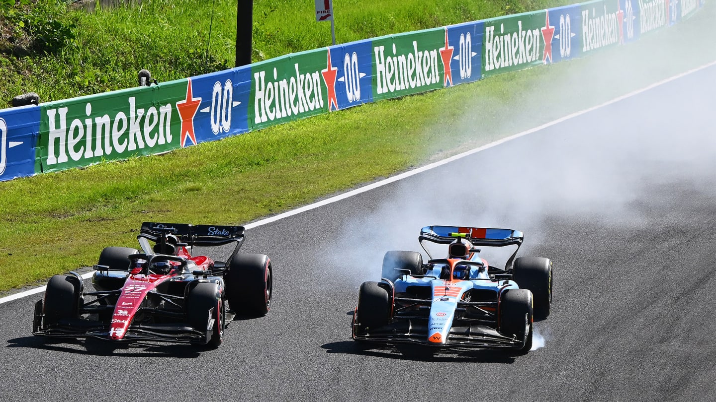 SUZUKA, JAPAN - SEPTEMBER 24: Logan Sargeant of United States driving the (2) Williams FW45 Mercedes locks a wheel under braking as he battles for track position with Valtteri Bottas of Finland driving the (77) Alfa Romeo F1 C43 Ferrari during the F1 Grand Prix of Japan at Suzuka International Racing Course on September 24, 2023 in Suzuka, Japan. (Photo by Clive Mason/Getty Images)