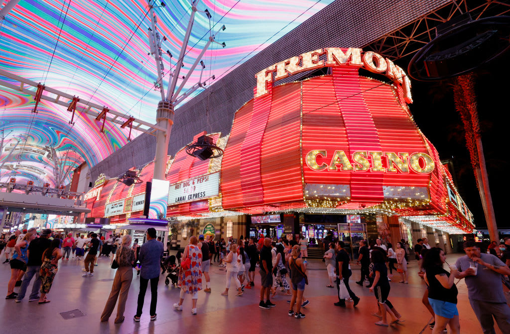 LAS VEGAS, NEVADA - MAY 31:  Visitors walk by the Fremont Hotel & Casino under the Viva Vision