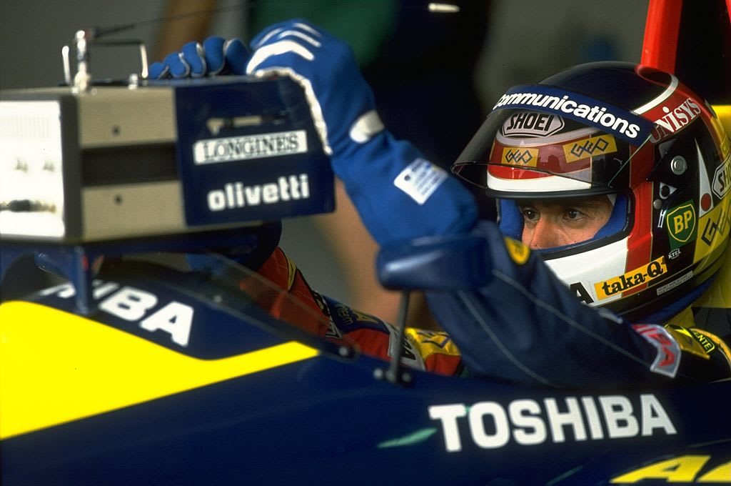 1990:  Aguri Suzuki of Japan checks the lap times in his Lola Lamborghini before the Portuguese