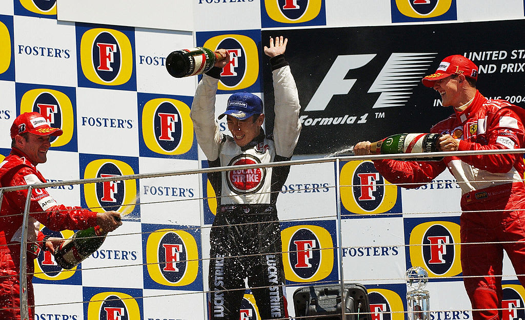 INDIANAPOLIS, UNITED STATES:  Japanese F1 BAR Honda driver Takuma Sato (C) is sprayed by champagne