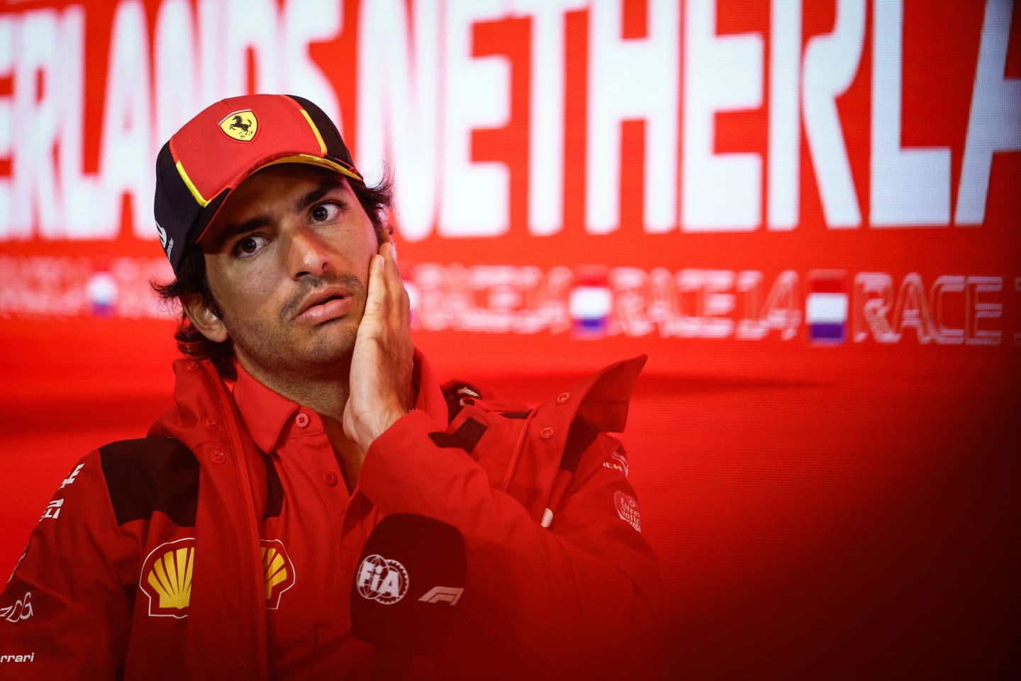 Ferrari's Spanish driver Carlos Sainz Jr gestures during a press conference ahead of the Dutch Formula One Grand Prix, in the coastal town of Zandvoort on August 24, 2023. The 2023 Dutch Grand Prix will take place on August 27, 2023. (Photo by Simon Wohlfahrt / AFP) (Photo by SIMON WOHLFAHRT/AFP via Getty Images)
