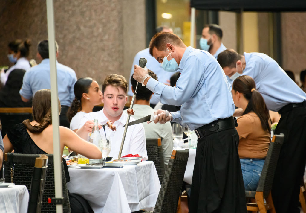 NEW YORK, NEW YORK - AUGUST 21: People dine at Fogo de Chao Brazilian Steakhouse in midtown as the