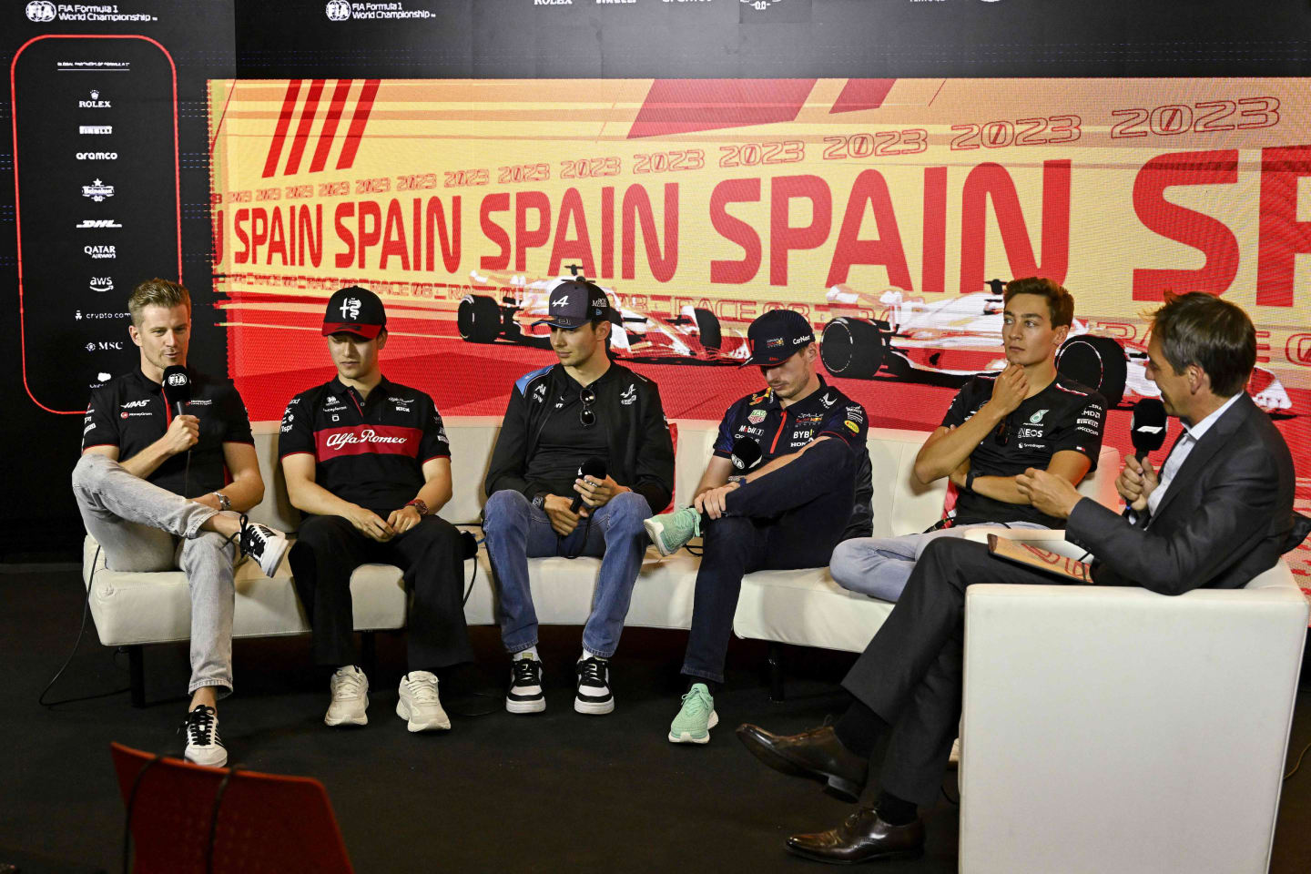 (From L) Haas F1 Team's German driver Nico Hulkenberg, Alfa Romeo's Chinese driver Zhou Guanyu, Alpine's French driver Esteban Ocon, Red Bull Racing's Dutch driver Max Verstappen and Mercedes' British driver George Russell address a press conference ahead of the Spanish Formula One Grand Prix at the Circuit de Catalunya on June 1, 2023 in Montmelo, on the outskirts of Barcelona. (Photo by JAVIER SORIANO / AFP) (Photo by JAVIER SORIANO/AFP via Getty Images)