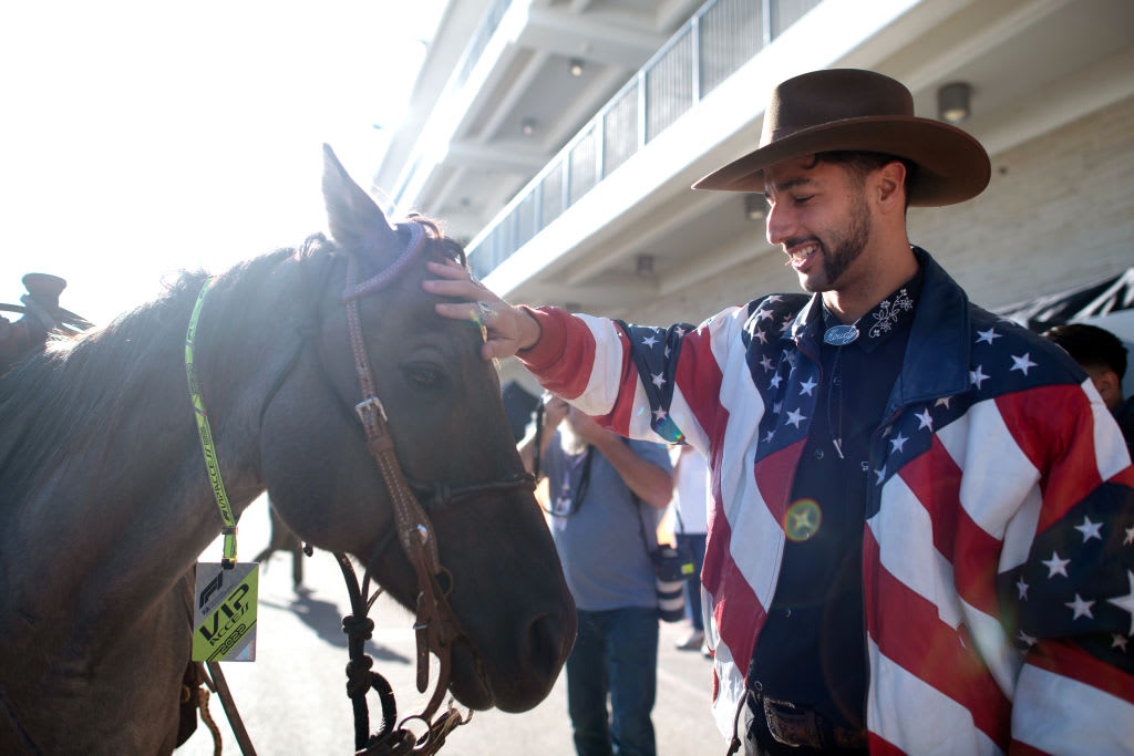 AUSTIN, TEXAS - OCTOBER 20: Daniel Ricciardo of Australia and McLaren pets a horse in the Paddock