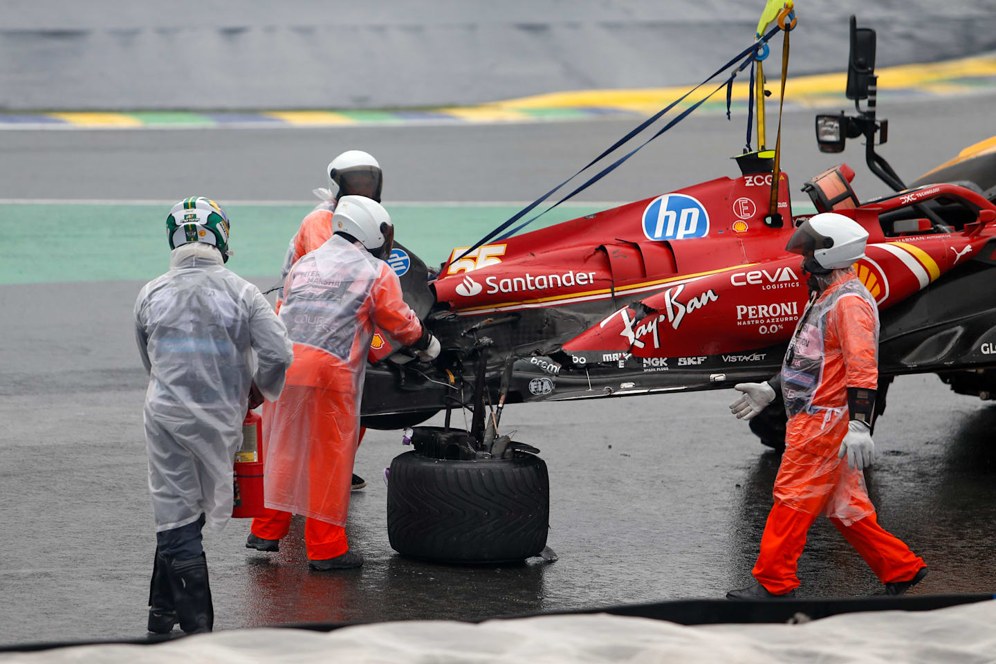 The car of Ferrari's Spanish driver Carlos Sainz is removed from the track after an accident during