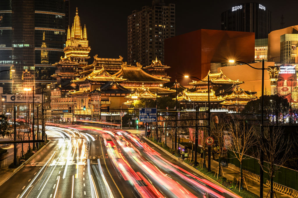 TOPSHOT - This long exposure picture shows traffic along a road leading to the Jing'an Temple in