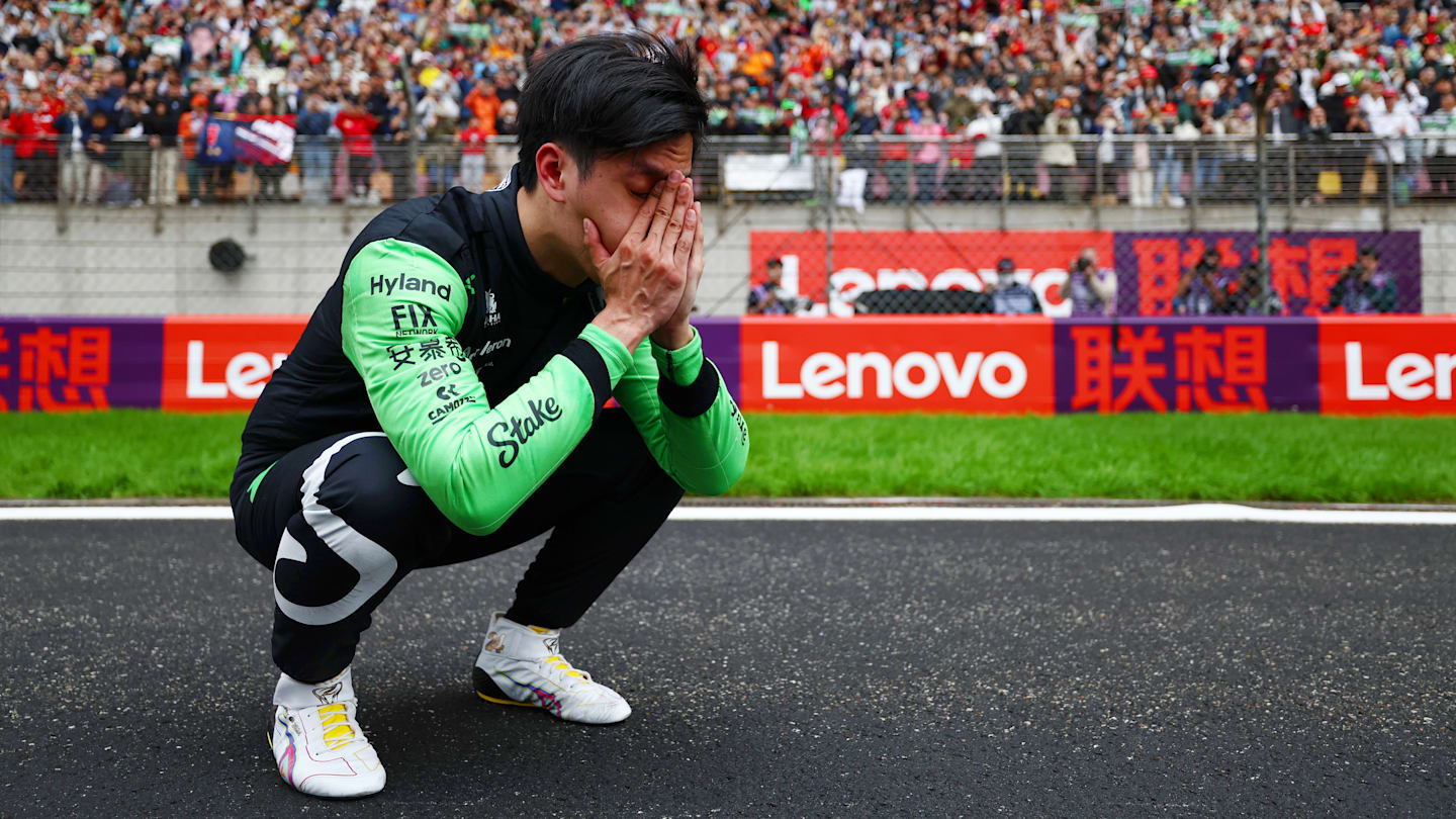 21 April 2024: Guanyu Zhou of Kick Sauber with his head in his hands crouching on the main straight at the Chinese Grand Prix