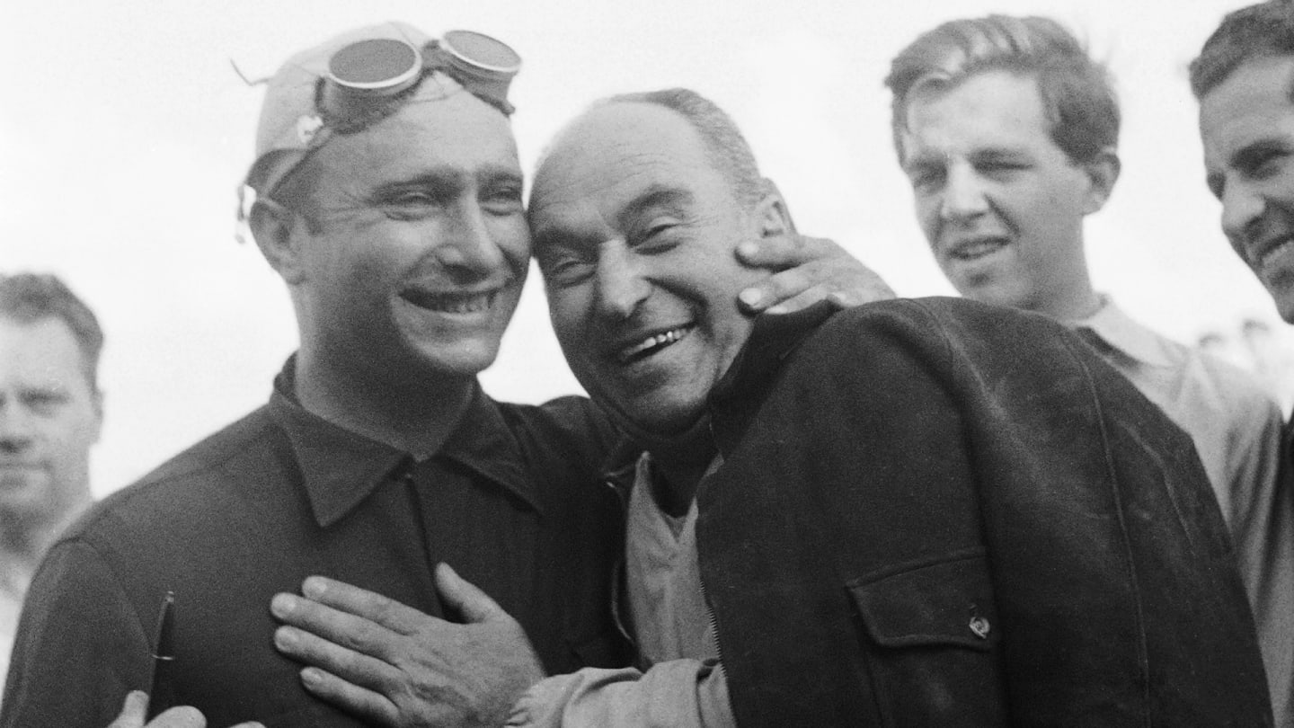 Fagioli, the oldest race winner in F1 history, seen here (centre) sharing a smile with Fangio
