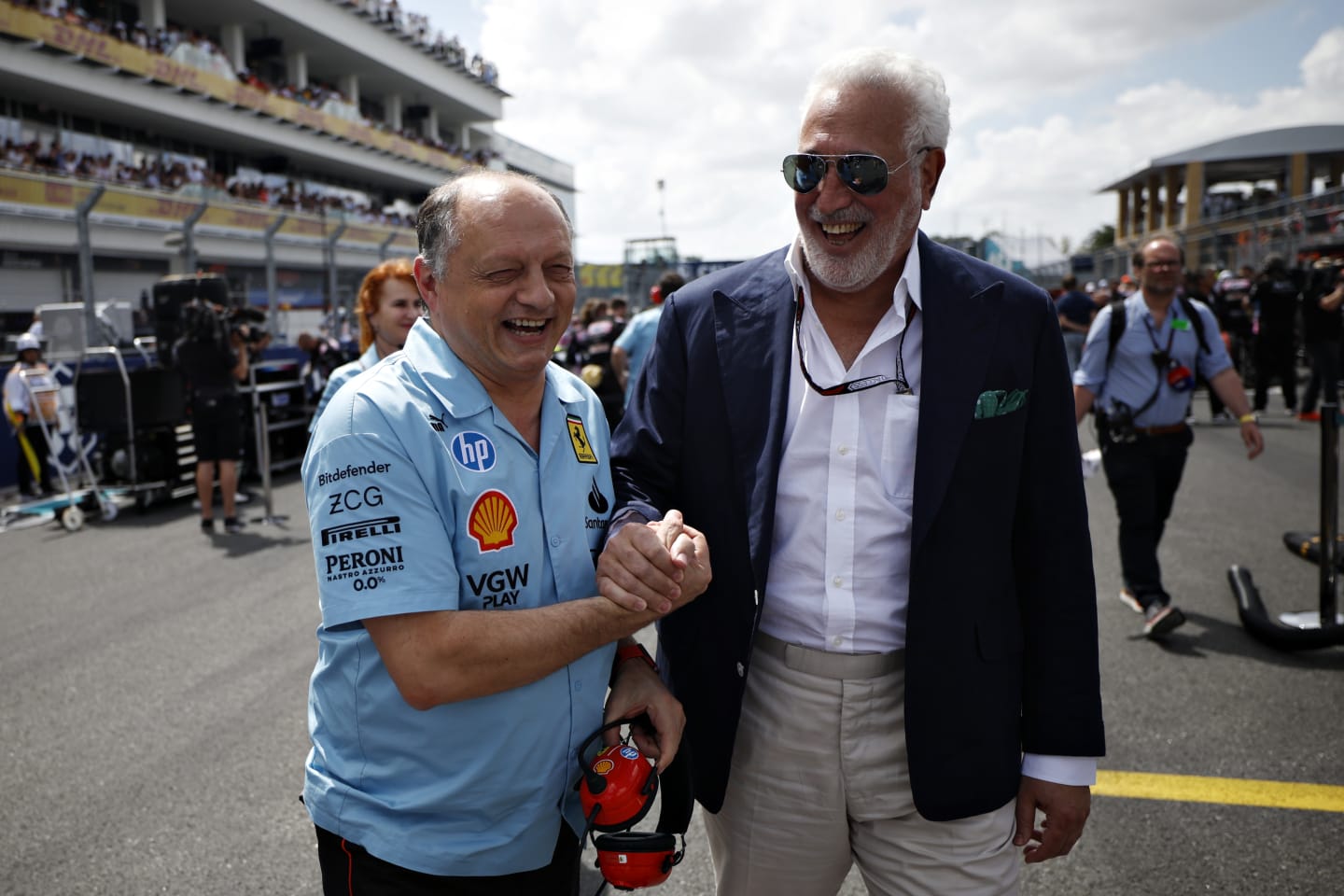 MIAMI, FLORIDA - MAY 05: Owner of Aston Martin F1 Team Lawrence Stroll shakes hands with Ferrari