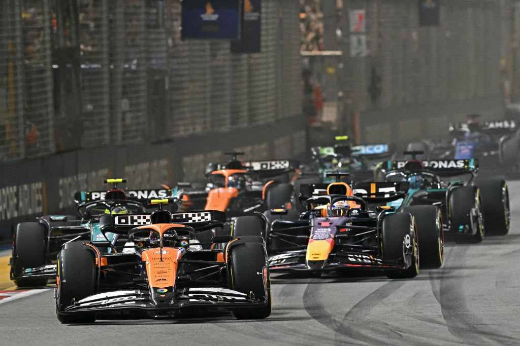 McLaren's British driver Lando Norris (front) leads the pack as he drives at the start of the