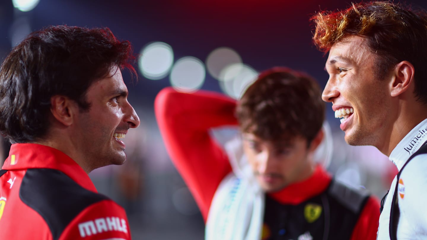 LUSAIL CITY, QATAR - OCTOBER 08: Carlos Sainz of Spain and Ferrari talks with Alexander Albon of Thailand and Williams on the grid prior to the F1 Grand Prix of Qatar (Photo by Dan Istitene - Formula 1/Formula 1 via Getty Images)