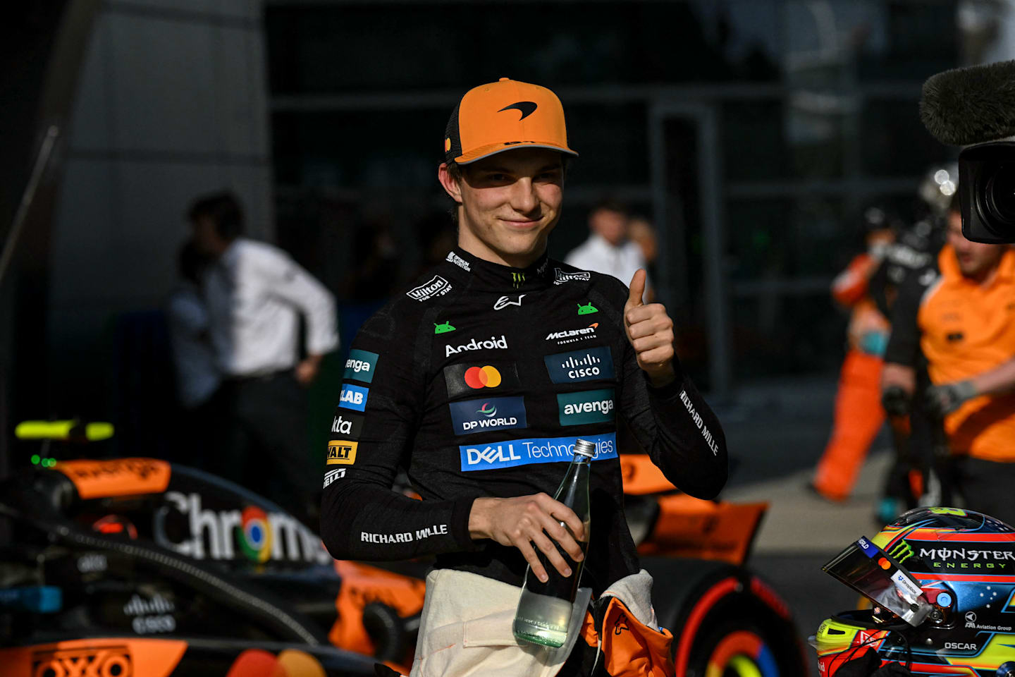 TOPSHOT - McLaren's Australian driver Oscar Piastri gives a thumbs as he celebrates taking pole