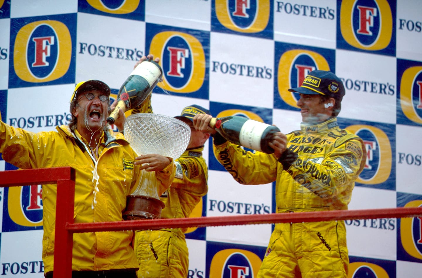 Race winner Damon Hill (GBR) Jordan and second placed Ralf Schumacher (GER) Jordan douse team boss