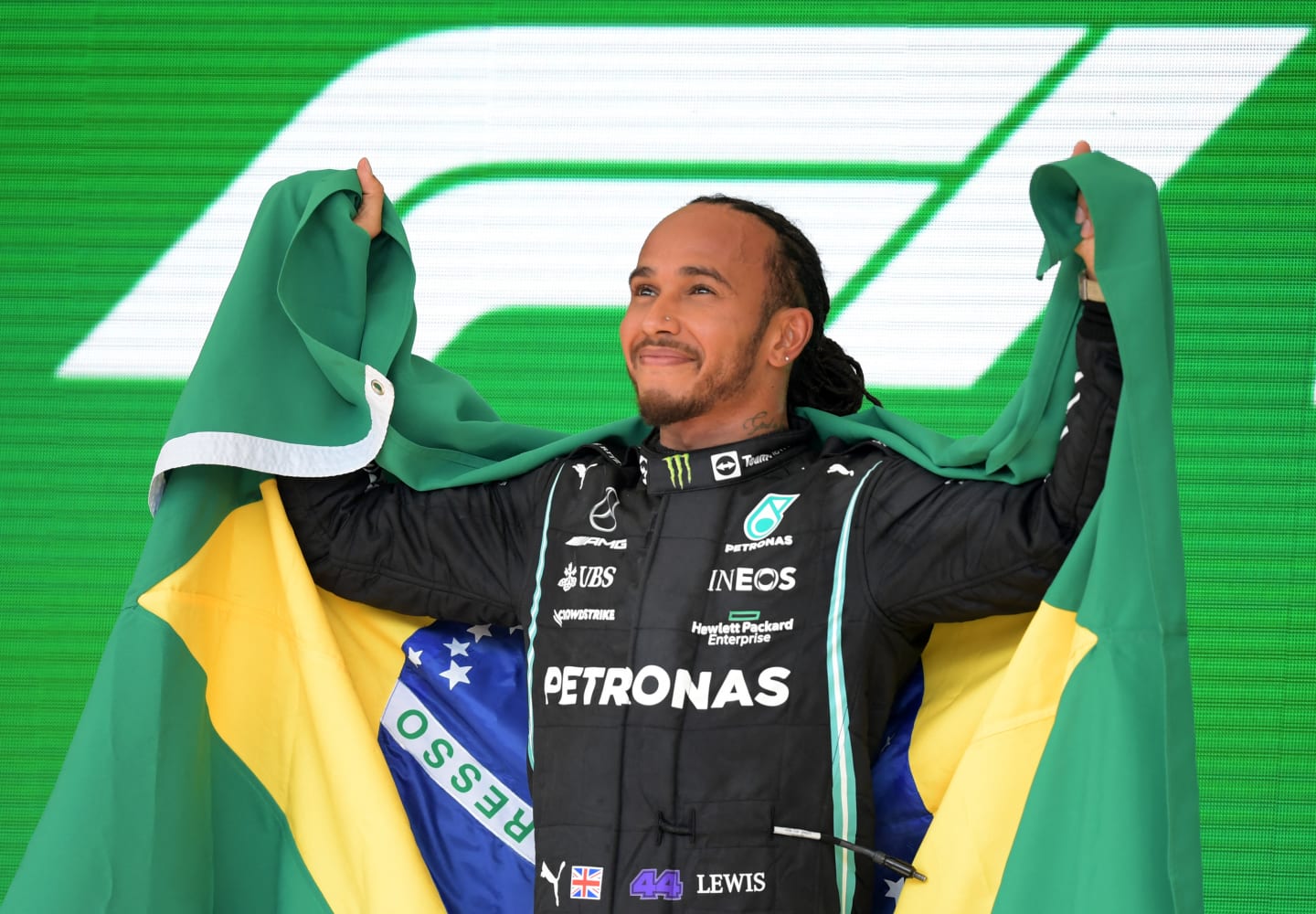 Mercedes' British driver Lewis Hamilton celebrates on the podium after winning Brazil's Formula One