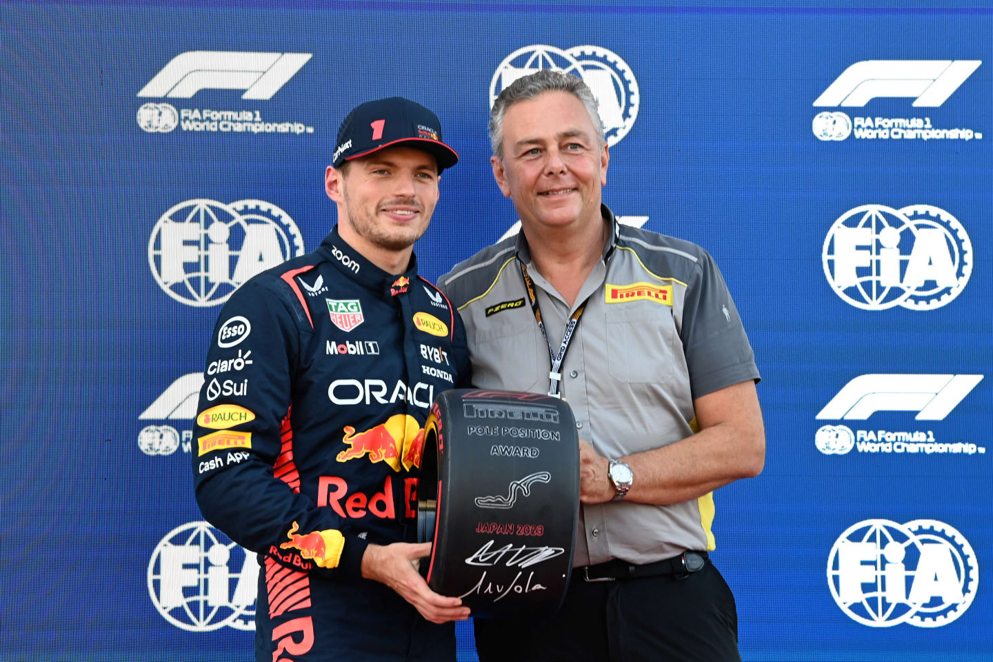 SUZUKA, JAPAN - SEPTEMBER 23: Pole man Max Verstappen, Red Bull Racing, receives his Pirelli Pole Position Award from Mario Isola, Racing Manager, Pirelli Motorsport during the Japanese GP at Suzuka on Saturday September 23, 2023 in Suzuka, Japan. (Photo by Mark Sutton / LAT Images)