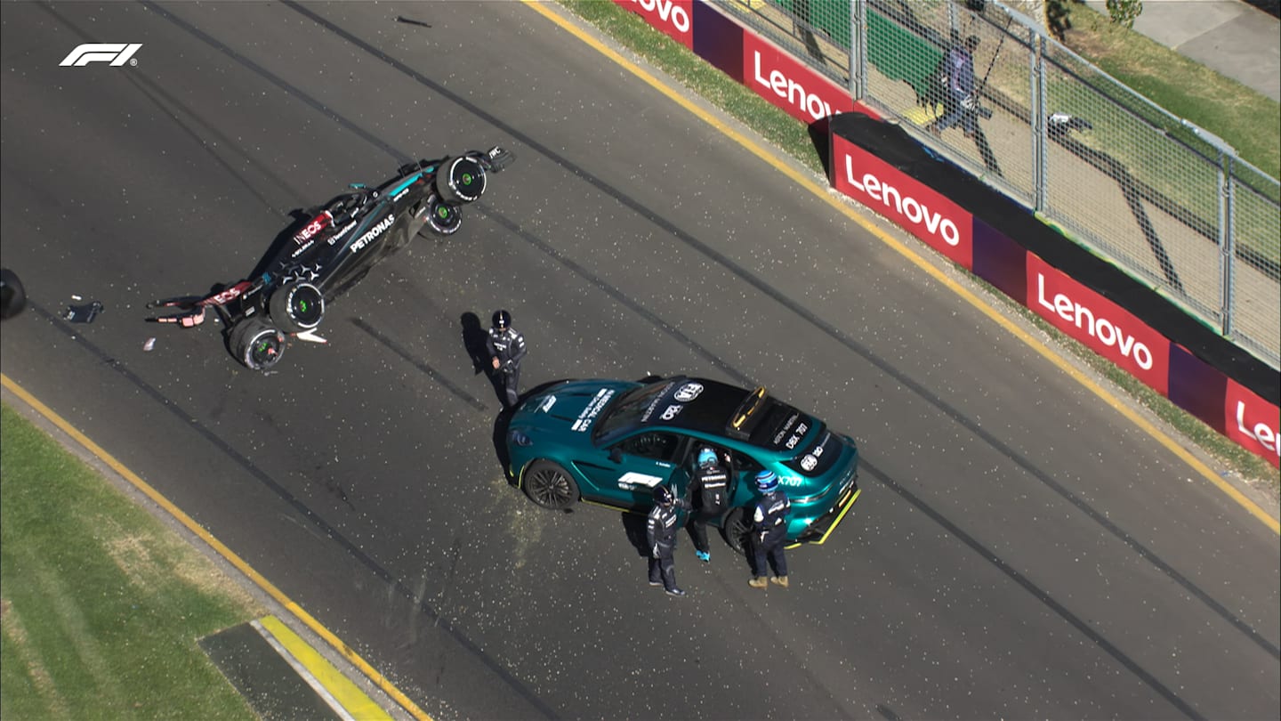 24 March 2024: George Russell getting in the medical car at the Australian Grand Prix as his Mercedes lies on its side further down the track