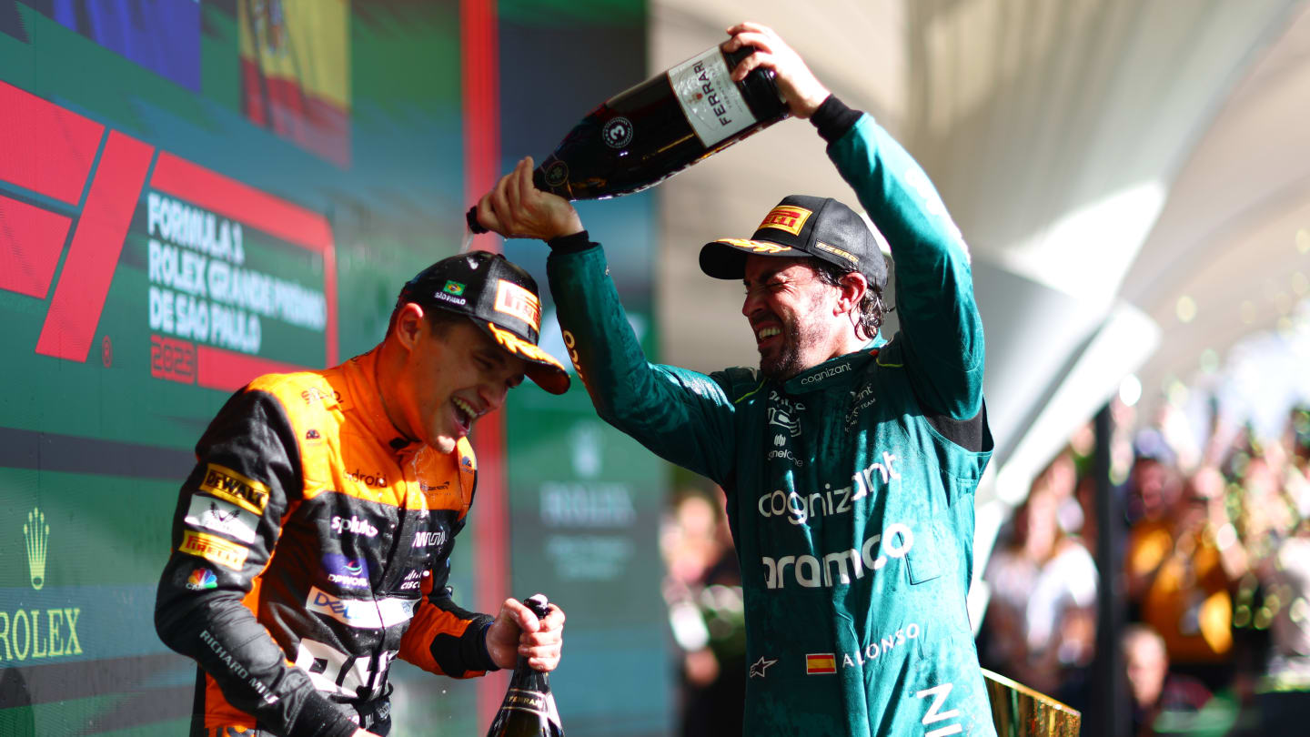 SAO PAULO, BRAZIL - NOVEMBER 05: Second placed Lando Norris of Great Britain and McLaren and Third placed Fernando Alonso of Spain and Aston Martin F1 Team celebrate on the podium during the F1 Grand Prix of Brazil at Autodromo Jose Carlos Pace on November 05, 2023 in Sao Paulo, Brazil. (Photo by Dan Istitene - Formula 1/Formula 1 via Getty Images)
