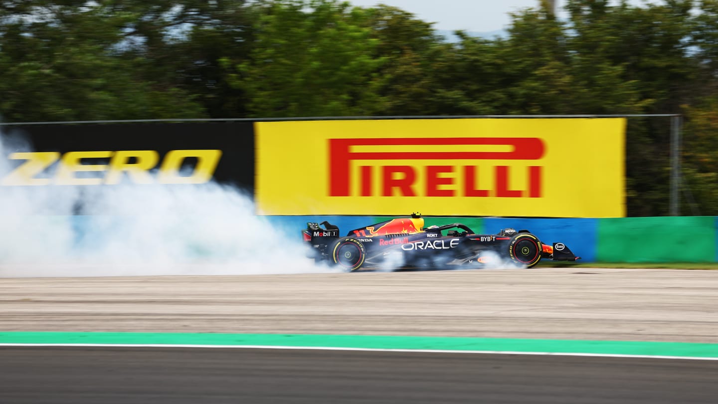 BUDAPEST, HUNGARY - JULY 21: Sergio Perez of Mexico driving the (11) Oracle Red Bull Racing RB19 crashes during practice ahead of the F1 Grand Prix of Hungary at Hungaroring on July 21, 2023 in Budapest, Hungary. (Photo by Bryn Lennon - Formula 1/Formula 1 via Getty Images)