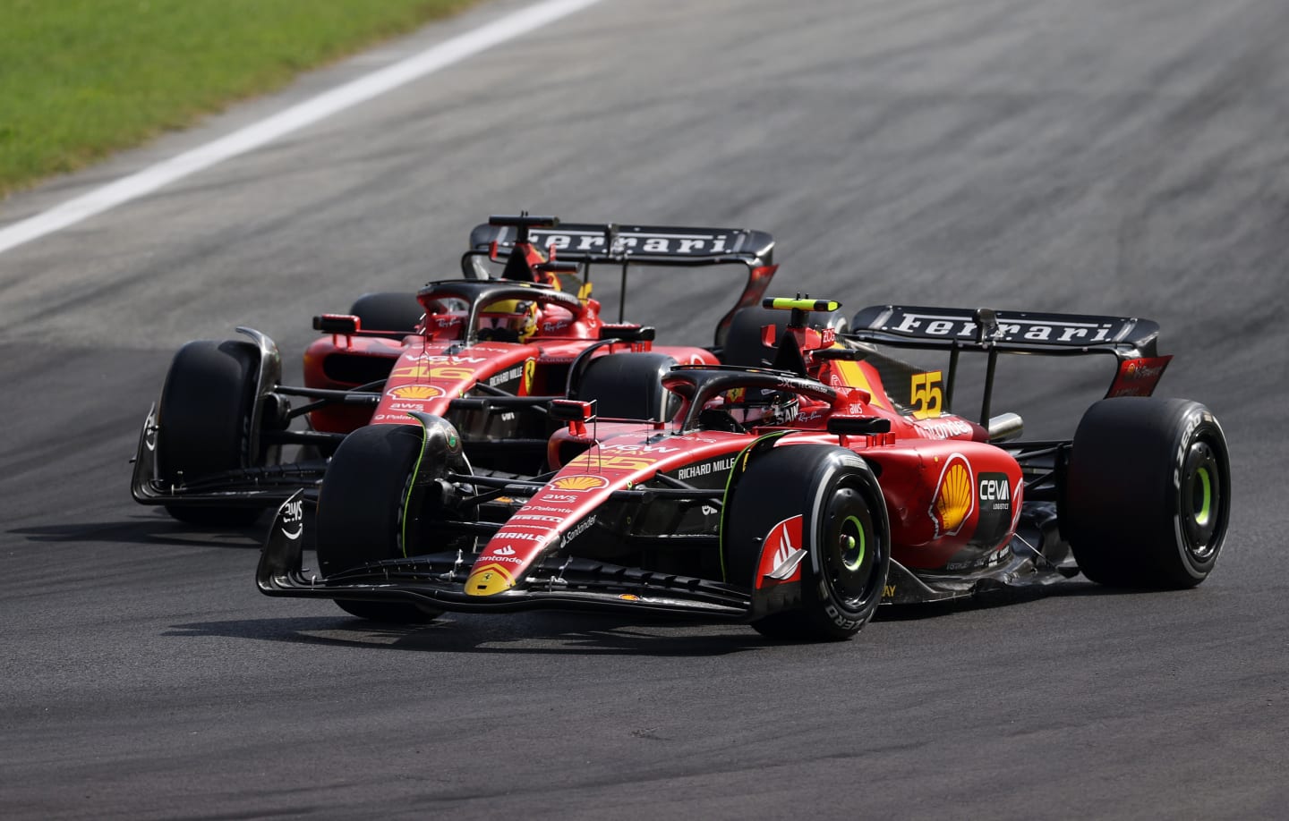 MONZA, ITALY - SEPTEMBER 03: Carlos Sainz of Spain driving (55) the Ferrari SF-23 leads Charles Leclerc of Monaco driving the (16) Ferrari SF-23 during the F1 Grand Prix of Italy at Autodromo Nazionale Monza on September 03, 2023 in Monza, Italy. (Photo by Ryan Pierse/Getty Images)