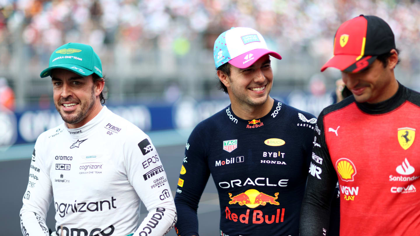 MIAMI, FLORIDA - MAY 06: Pole position qualifier Sergio Perez of Mexico and Oracle Red Bull Racing (C), Second placed qualifier Fernando Alonso of Spain and Aston Martin F1 Team (L) and Third placed qualifier Carlos Sainz of Spain and Ferrari (R) talk in parc ferme during qualifying ahead of the F1 Grand Prix of Miami at Miami International Autodrome on May 06, 2023 in Miami, Florida. (Photo by Dan Istitene - Formula 1/Formula 1 via Getty Images)