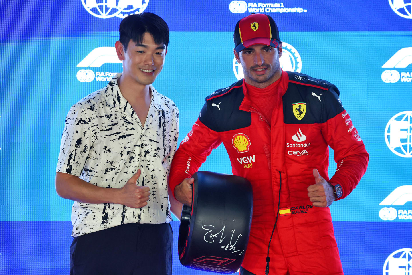 SINGAPORE, SINGAPORE - SEPTEMBER 16: Pole position qualifier Carlos Sainz of Spain and Ferrari is presented with the Pirelli Pole Position Award by Eric Nam in parc ferme during qualifying ahead of the F1 Grand Prix of Singapore at Marina Bay Street Circuit on September 16, 2023 in Singapore, Singapore. (Photo by Russell Batchelor/Getty Images)