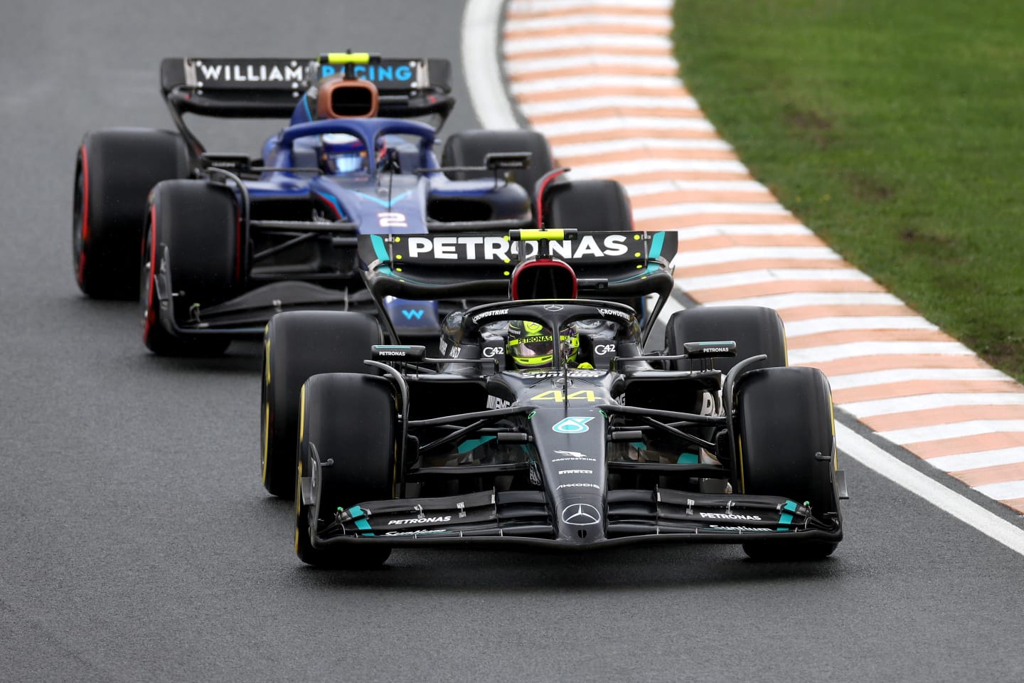 ZANDVOORT, NETHERLANDS - AUGUST 27: Lewis Hamilton of Great Britain driving the (44) Mercedes AMG Petronas F1 Team W14 leads Logan Sargeant of United States driving the (2) Williams FW45 Mercedes during the F1 Grand Prix of The Netherlands at Circuit Zandvoort on August 27, 2023 in Zandvoort, Netherlands. (Photo by Lars Baron/Getty Images)