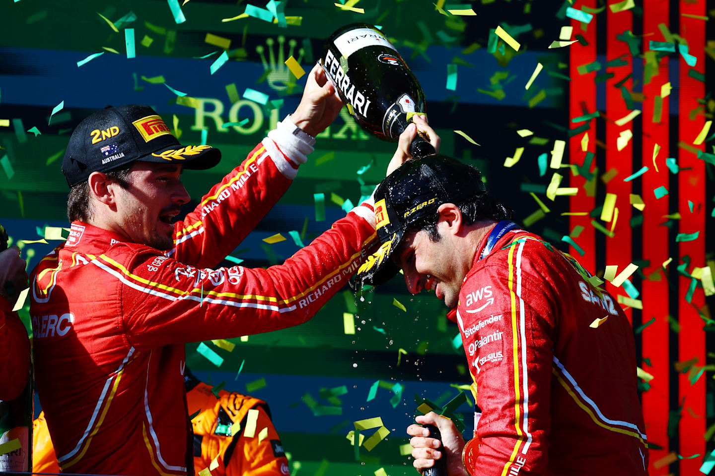 MELBOURNE, AUSTRALIA - MARCH 24: Race winner Carlos Sainz of Spain and Ferrari and Second placed Charles Leclerc of Monaco and Ferrari celebrate on the podium during the F1 Grand Prix of Australia. (Photo by Mark Thompson/Getty Images)