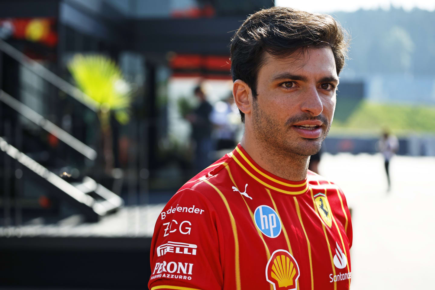 SPIELBERG, AUSTRIA - JUNE 29: Carlos Sainz of Spain and Ferrari walks in the Paddock prior to the