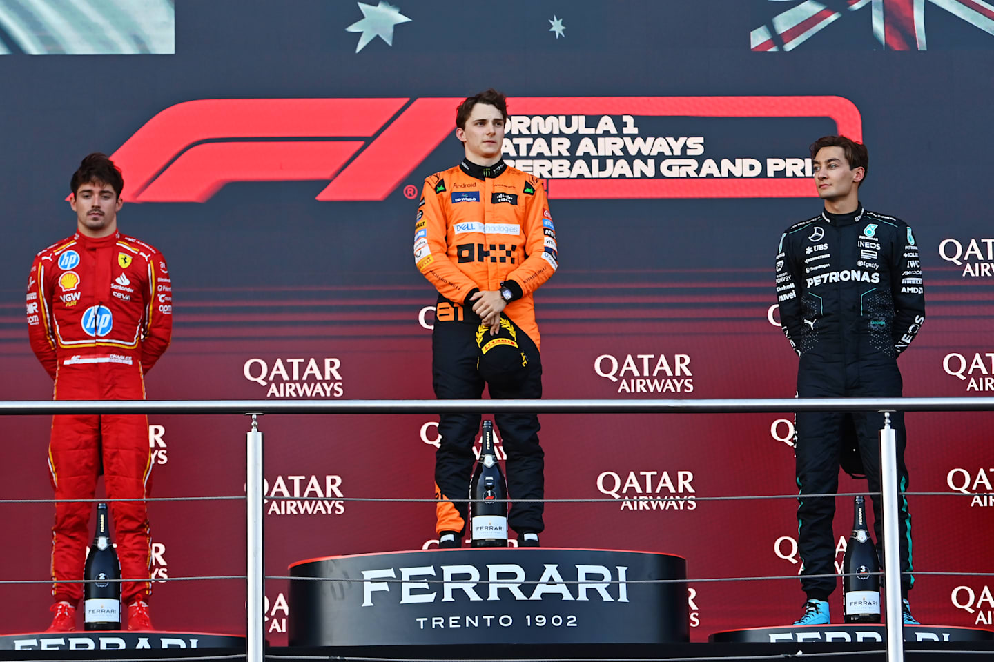 BAKU, AZERBAIJAN - SEPTEMBER 15: Race winner Oscar Piastri of McLaren, Second placed Charles Leclerc of Ferrari and Third placed George Russell of Mercedes celebrate on the podium during the F1 Grand Prix of Azerbaijan. (Photo by James Sutton/Getty Images)