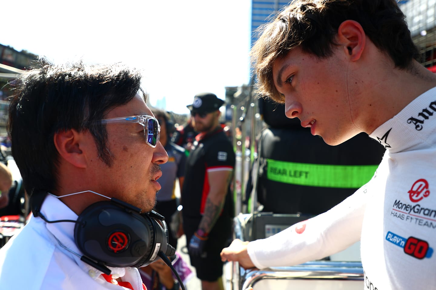 BAKU, AZERBAIJAN - SEPTEMBER 15: Oliver Bearman of Great Britain and Haas F1 talks with Haas F1 Team Principal Ayao Komatsu on the grid during the F1 Grand Prix of Azerbaijan at Baku City Circuit. (Photo by Peter Fox - Formula 1/Formula 1 via Getty Images)