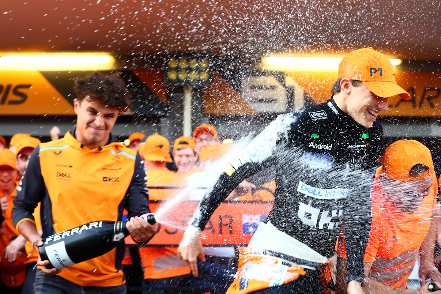 BAKU, AZERBAIJAN - SEPTEMBER 15: Race winner Oscar Piastri of Australia and McLaren and 4th placed Lando Norris of Great Britain and McLaren celebrate with their team in the Pitlane after the F1 Grand Prix of Azerbaijan at Baku City Circuit on September 15, 2024 in Baku, Azerbaijan. (Photo by Clive Rose - Formula 1/Formula 1 via Getty Images)