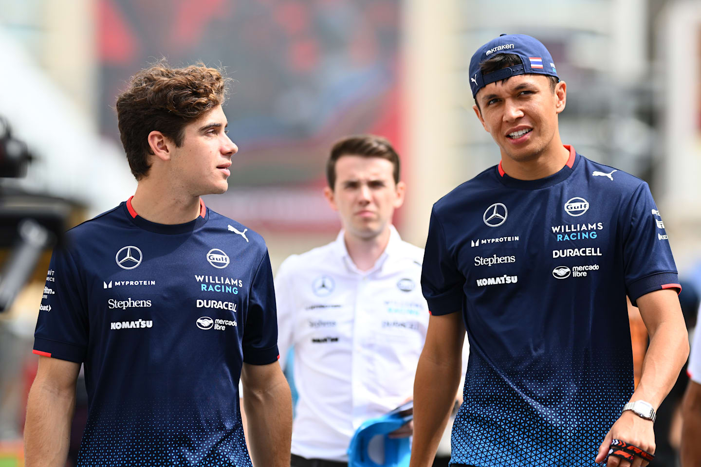 BAKU, AZERBAIJAN - SEPTEMBER 13: Franco Colapinto of Argentina and Williams and Alexander Albon of Thailand and Williams walk in the Paddock prior to practice ahead of the F1 Grand Prix of Azerbaijan. (Photo by Clive Mason/Getty Images)