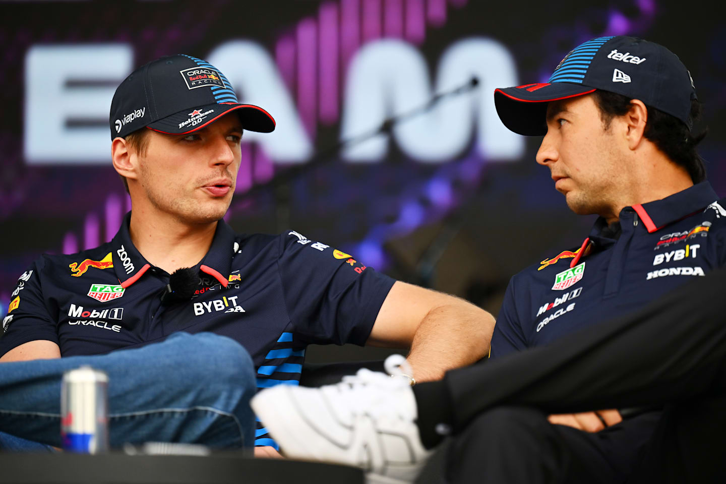 BAKU, AZERBAIJAN - SEPTEMBER 14: Max Verstappen of the Netherlands and Oracle Red Bull Racing and Sergio Perez of Mexico and Oracle Red Bull Racing talk on the fan stage prior to final practice. (Photo by Dan Mullan/Getty Images)