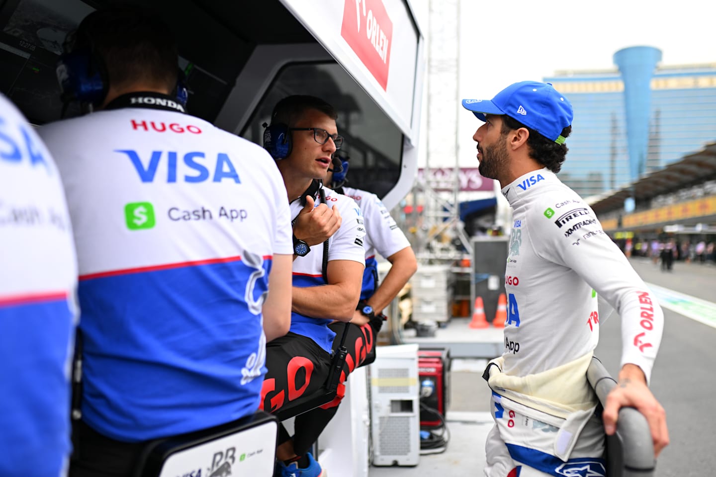 BAKU, AZERBAIJAN - SEPTEMBER 14: Daniel Ricciardo of Australia and Visa Cash App RB talks with race engineer Pierre Hamelin on the pitwall during final practice ahead of the F1 Grand Prix of Azerbaijan at Baku City Circuit on September 14, 2024 in Baku, Azerbaijan. (Photo by Rudy Carezzevoli/Getty Images)