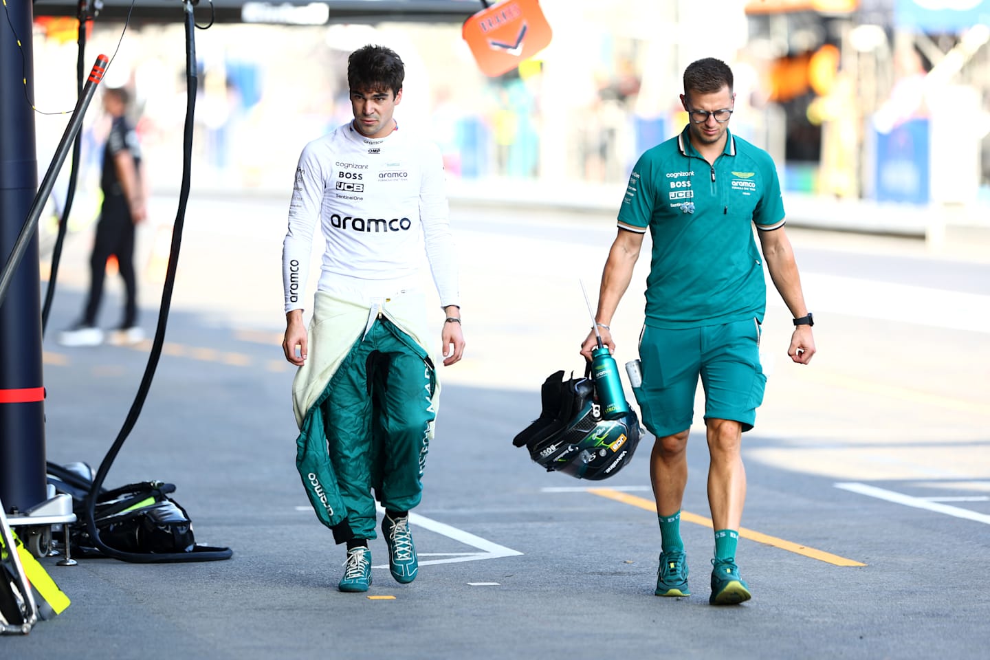 BAKU, AZERBAIJAN - SEPTEMBER 14: 15th placed qualifier Lance Stroll of Canada and Aston Martin F1 Team walks in the Pitlane during qualifying ahead of the F1 Grand Prix of Azerbaijan at Baku City Circuit on September 14, 2024 in Baku, Azerbaijan. (Photo by Clive Rose - Formula 1/Formula 1 via Getty Images)