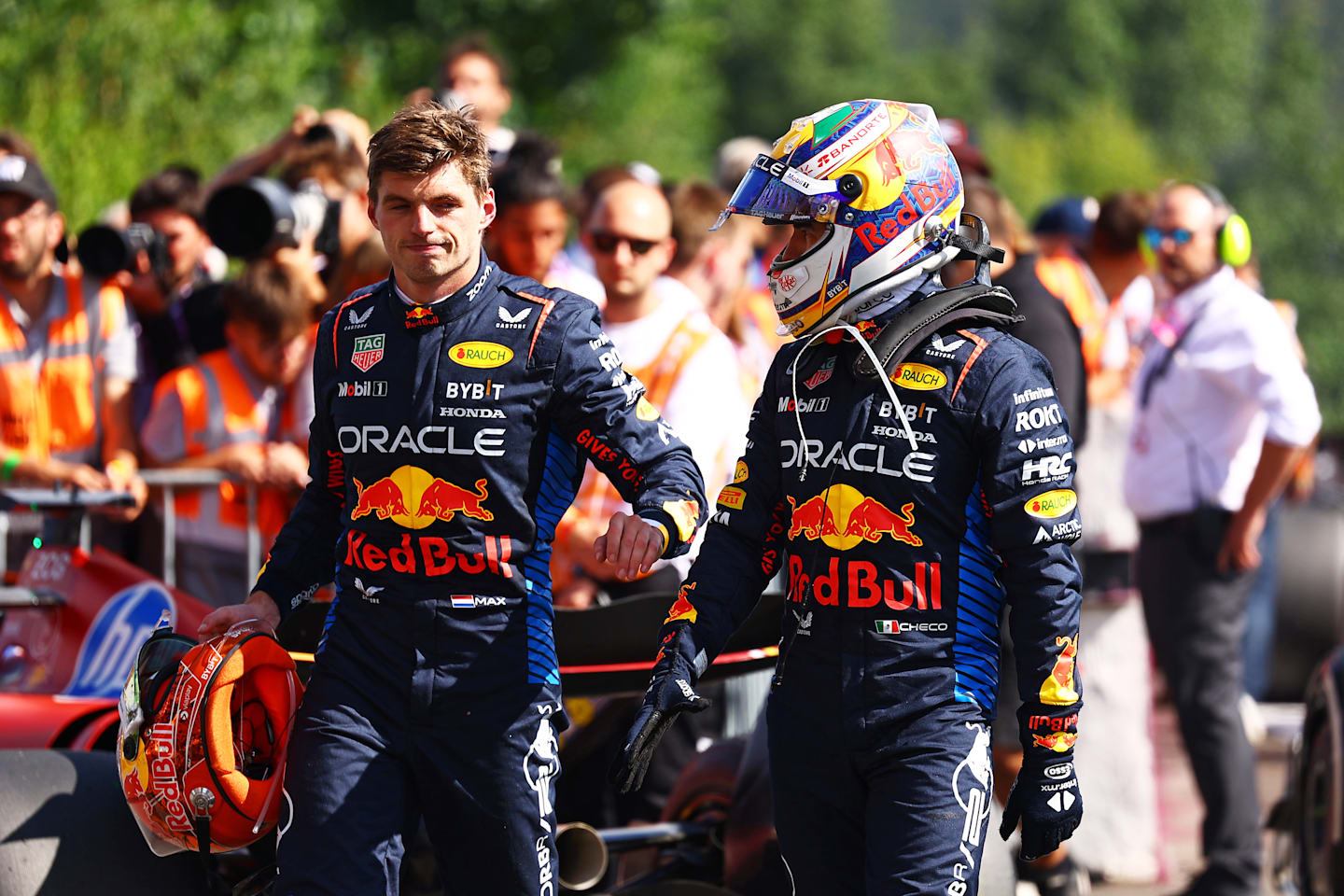 SPA, BELGIUM - JULY 28: 5th placed Max Verstappen of the Netherlands and Oracle Red Bull Racing and 8th placed Sergio Perez of Mexico and Oracle Red Bull Racing talk in parc ferme during the F1 Grand Prix of Belgium at Circuit de Spa-Francorchamps on July 28, 2024 in Spa, Belgium. (Photo by Mark Thompson/Getty Images)