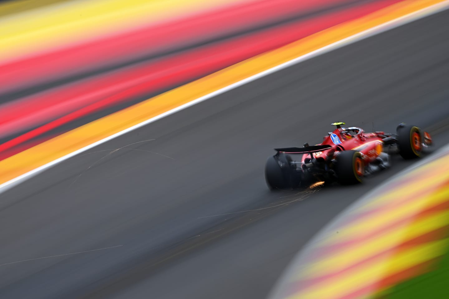 SPA, BELGIUM - JULY 26: Sparks fly behind Carlos Sainz of Spain driving (55) the Ferrari SF-24 during practice ahead of the F1 Grand Prix of Belgium at Circuit de Spa-Francorchamps on July 26, 2024 in Spa, Belgium. (Photo by Rudy Carezzevoli/Getty Images)