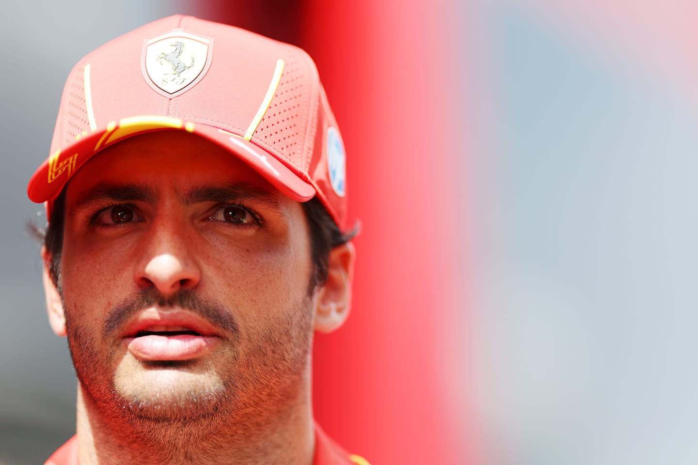 SPA, BELGIUM - JULY 25: Carlos Sainz of Spain and Ferrari looks on in the Paddock during previews