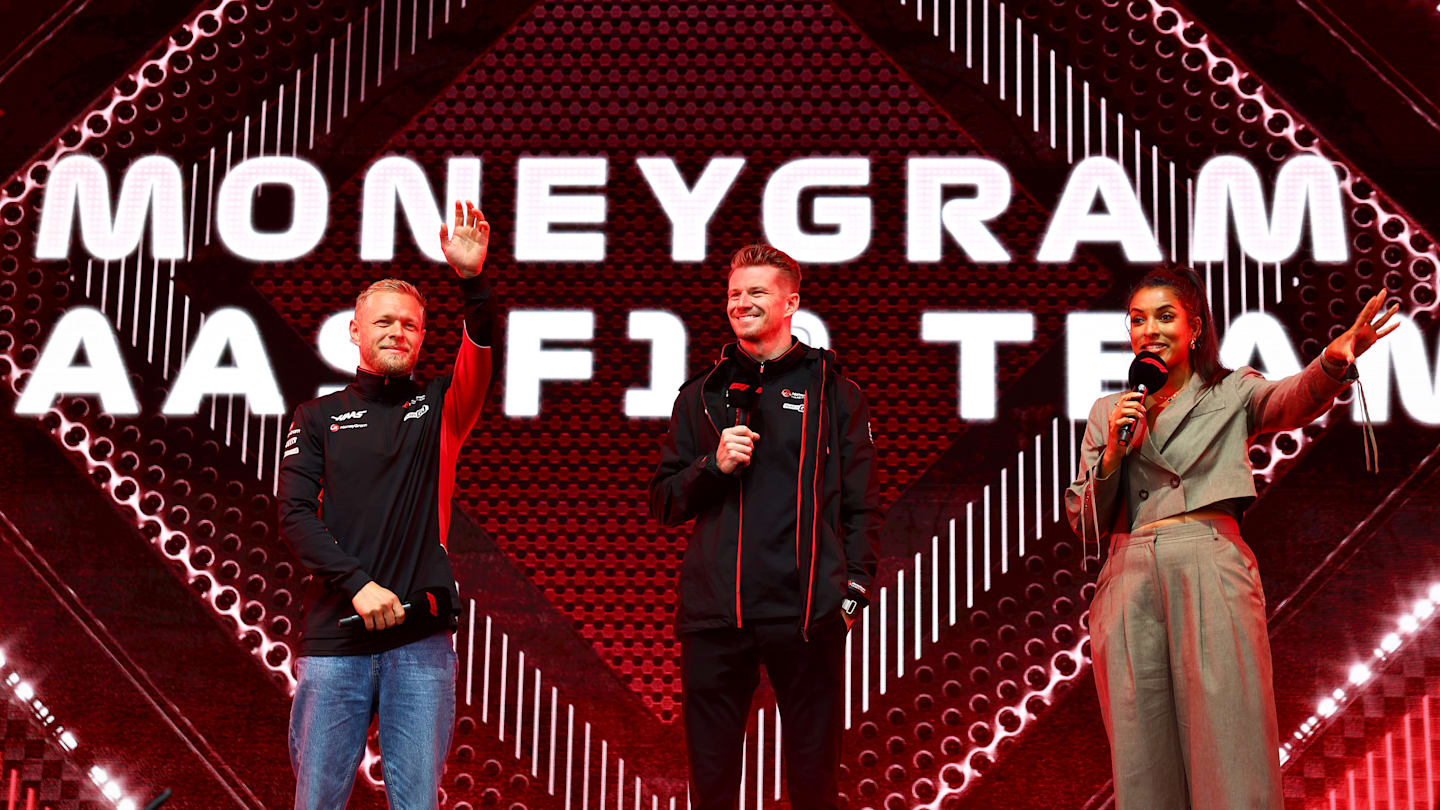 SPA, BELGIUM - JULY 27: Kevin Magnussen of Denmark and Haas F1 and Nico Hulkenberg of Germany and Haas F1 acknowledge the crowd on the fan stage prior to final practice. (Photo by Bryn Lennon - Formula 1/Formula 1 via Getty Images)