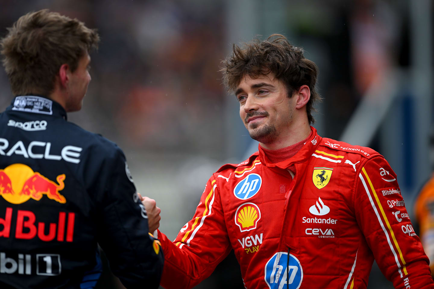 SPA, BELGIUM - JULY 27: Pole position qualifier Max Verstappen of the Netherlands and Oracle Red Bull Racing talks with Second placed qualifier Charles Leclerc of Monaco and Ferrari in parc ferme during qualifying ahead of the F1 Grand Prix of Belgium at Circuit de Spa-Francorchamps on July 27, 2024 in Spa, Belgium. (Photo by Rudy Carezzevoli/Getty Images)