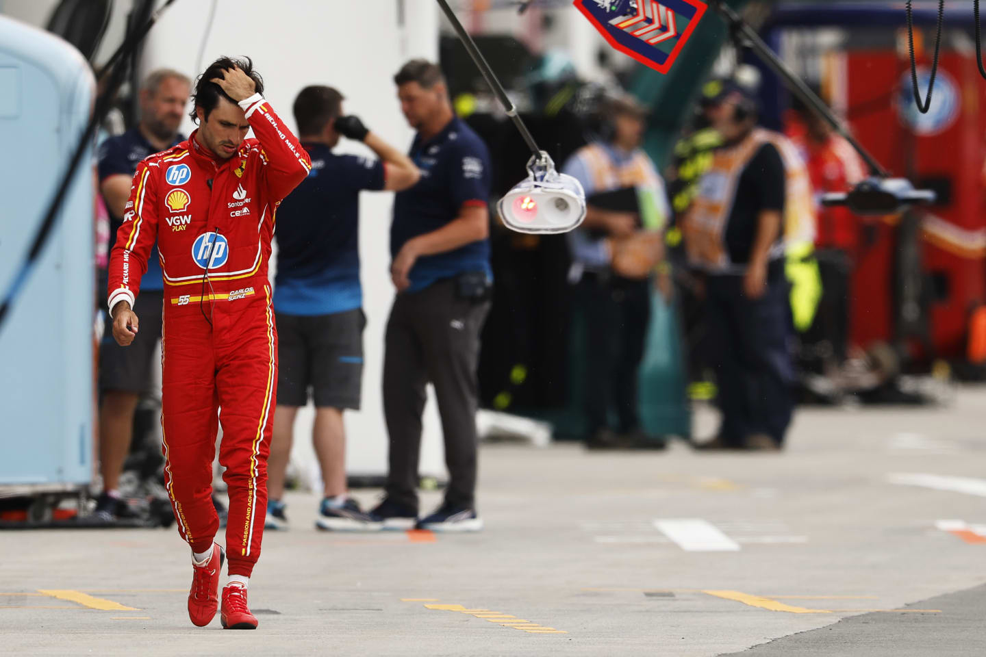 MONTREAL, QUEBEC - JUNE 08: 12th placed qualifier Carlos Sainz of Spain and Ferrari walks in the Pitlane during qualifying ahead of the F1 Grand Prix of Canada at Circuit Gilles Villeneuve on June 08, 2024 in Montreal, Quebec. (Photo by Chris Graythen/Getty Images)