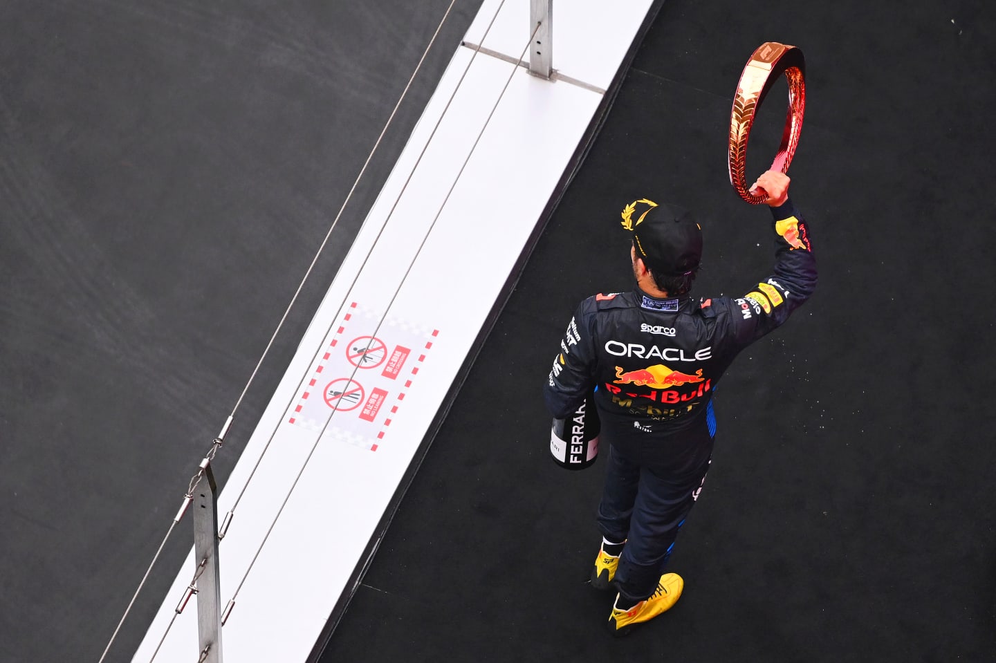 SHANGHAI, CHINA - APRIL 21: Third placed Sergio Perez of Mexico and Oracle Red Bull Racing celebrates on the podium during the F1 Grand Prix of China at Shanghai International Circuit on April 21, 2024 in Shanghai, China. (Photo by Clive Mason - Formula 1/Formula 1 via Getty Images)
