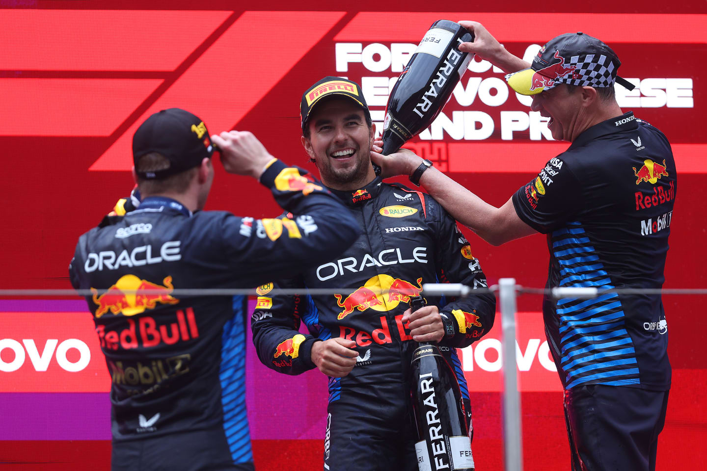 SHANGHAI, CHINA - APRIL 21: Race winner Max Verstappen, Third placed Sergio Perez of Mexico and Oracle Red Bull Racing and Oracle Red Bull Racing Head of Car Engineering Paul Monaghan celebrate on the podium. (Photo by Lars Baron/Getty Images)