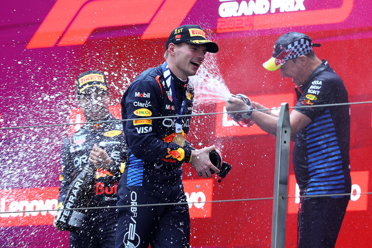 SHANGHAI, CHINA - APRIL 21: Race winner Max Verstappen of the Netherlands and Oracle Red Bull Racing, Third placed Sergio Perez of Mexico and Oracle Red Bull Racing and Oracle Red Bull Racing Head of Car Engineering Paul Monaghan celebrate on the podium during the F1 Grand Prix of China at Shanghai International Circuit on April 21, 2024 in Shanghai, China. (Photo by Lintao Zhang/Getty Images )